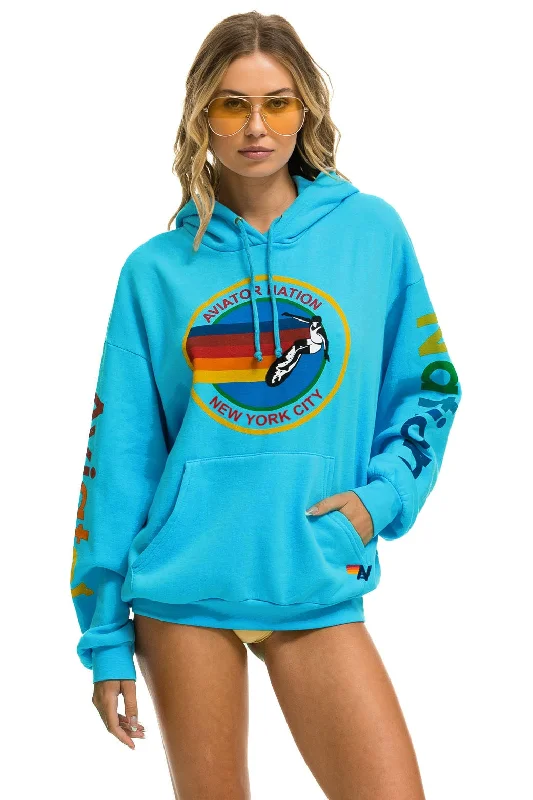 Women's graphic - printed sweatshirt featuring floral patterns for a feminine touchAVIATOR NATION NEW YORK CITY RELAXED PULLOVER HOODIE - NEON BLUE Women's graphic - printed sweatshirt featuring floral patterns for a feminine touchAVIATOR NATION NEW YORK CITY RELAXED PULLOVER HOODIE - NEON BLUE